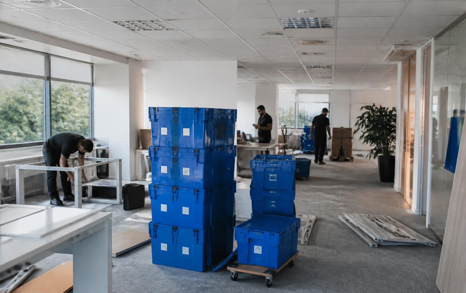 Moving crates stacked in a modern office during a relocation